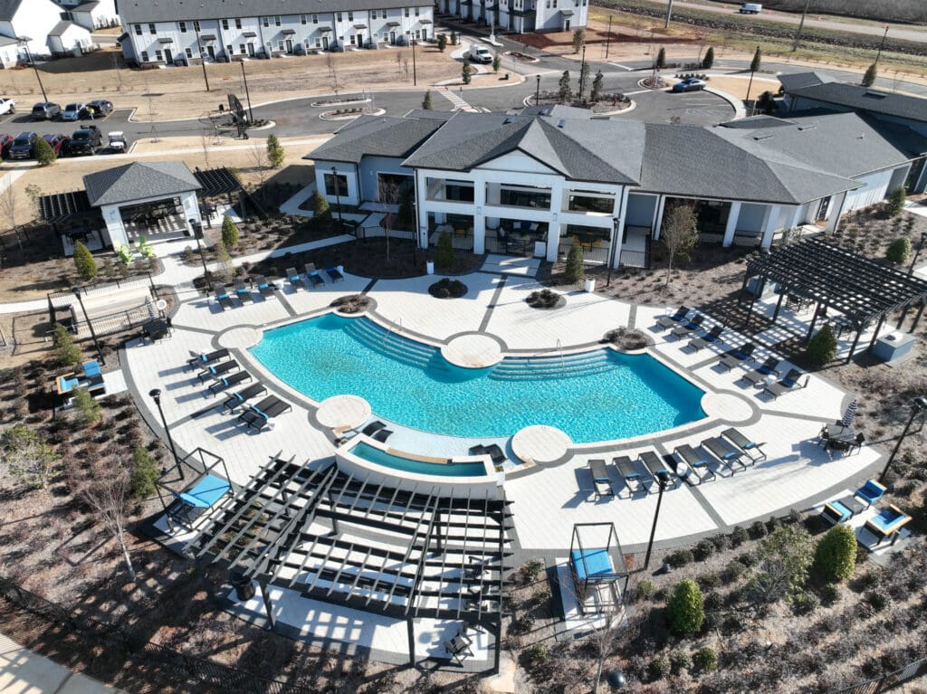 Luxury residential swimming pool with surrounding hardscapes and lounge area.