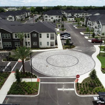 Modern residential apartment complex with landscaped courtyards and parking areas.