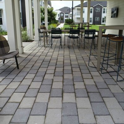 Clean outdoor patio with modern hardscape, seating, and dining areas.